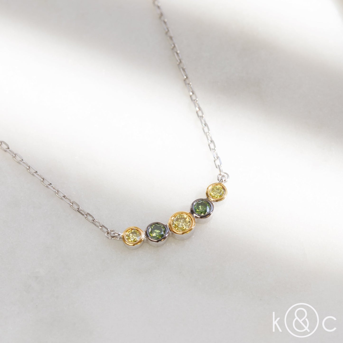 
                  
                    Kat & Chlo Yellow and Green Diamonds Smile Necklace
                  
                